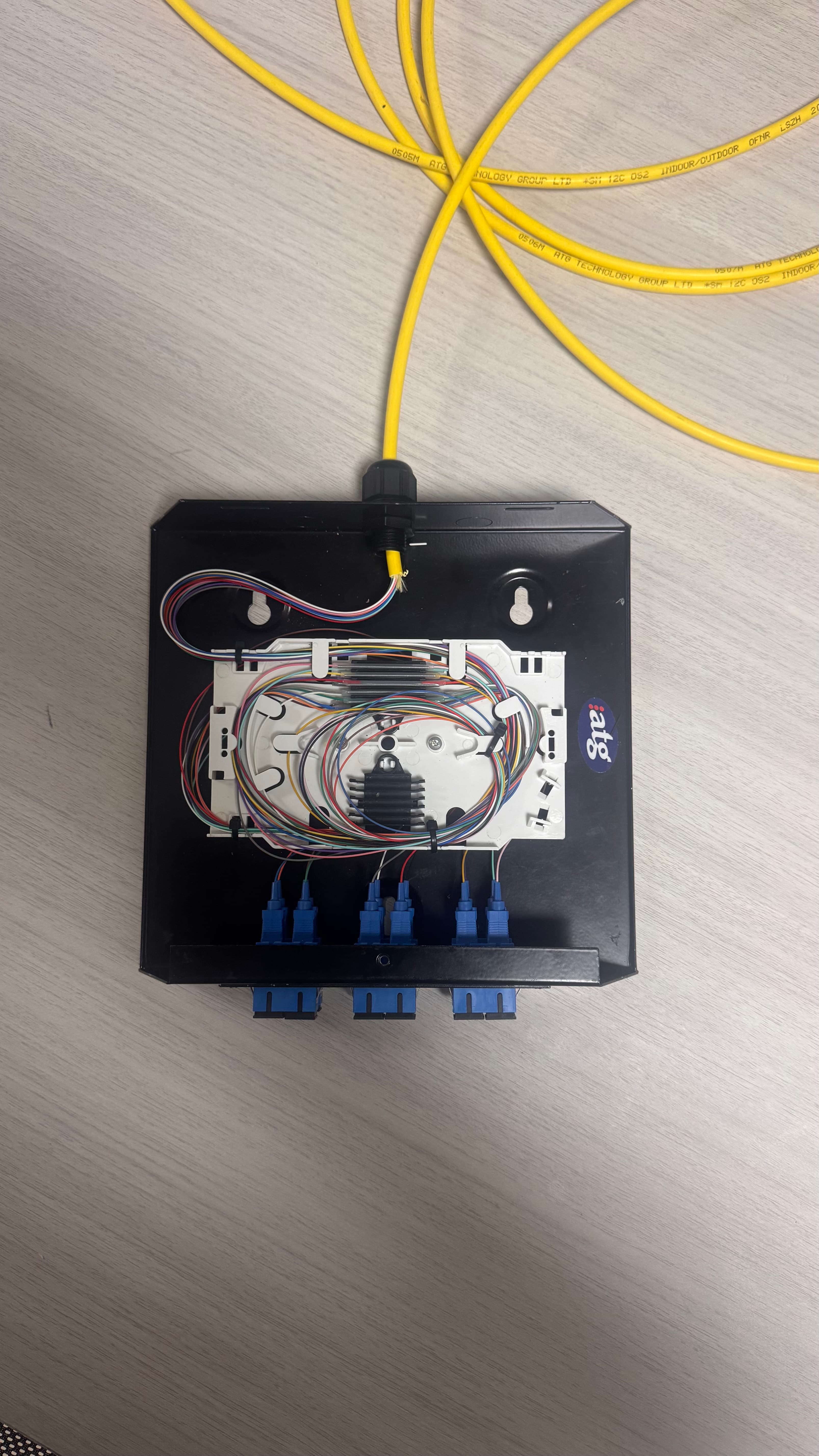 Open fibre splice enclosure showing organised fibre routing and connector ports